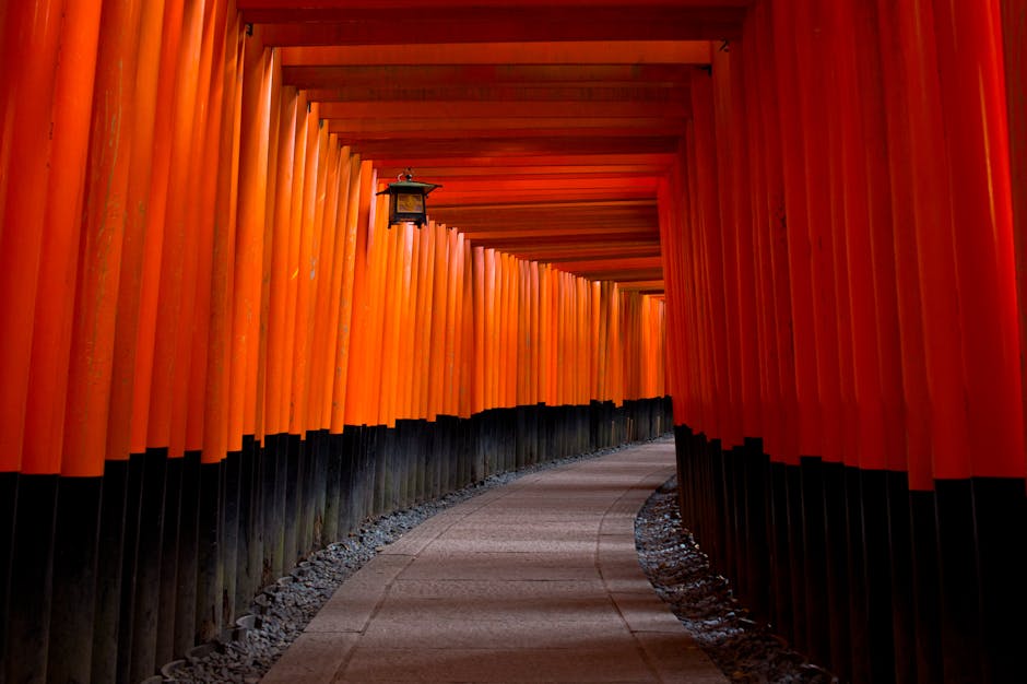 The iconic entrance path of Naesosa Temple, surrounded by towering autumn-hued maple trees and scattered leaves, creating a warm and inviting atmosphere for visitors