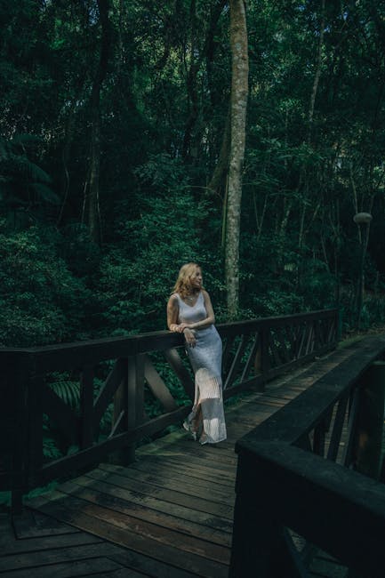 A serene spot by a mountain stream with a rustic wooden bench, surrounded by moss-covered rocks and lush greenery, perfect for quiet reflection and relaxation