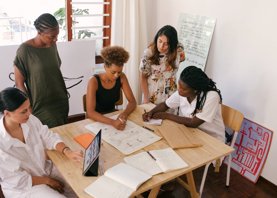 Team members around a digital table with holographic displays showing real-time project updates and collaborative input