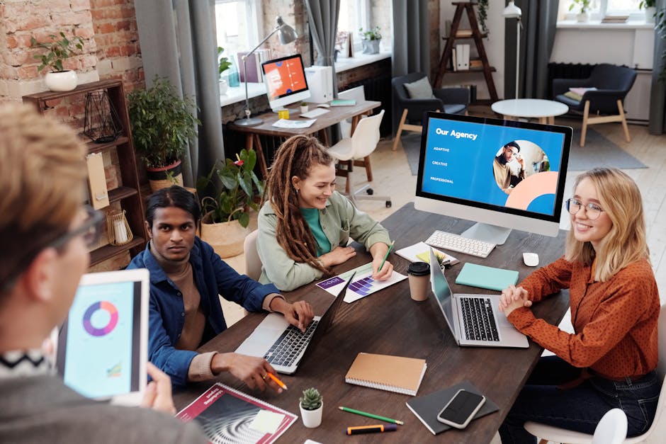 A cheerful group of people gathered around a computer screen, sharing insights on automated trading, symbolizing camaraderie and shared learning experiences